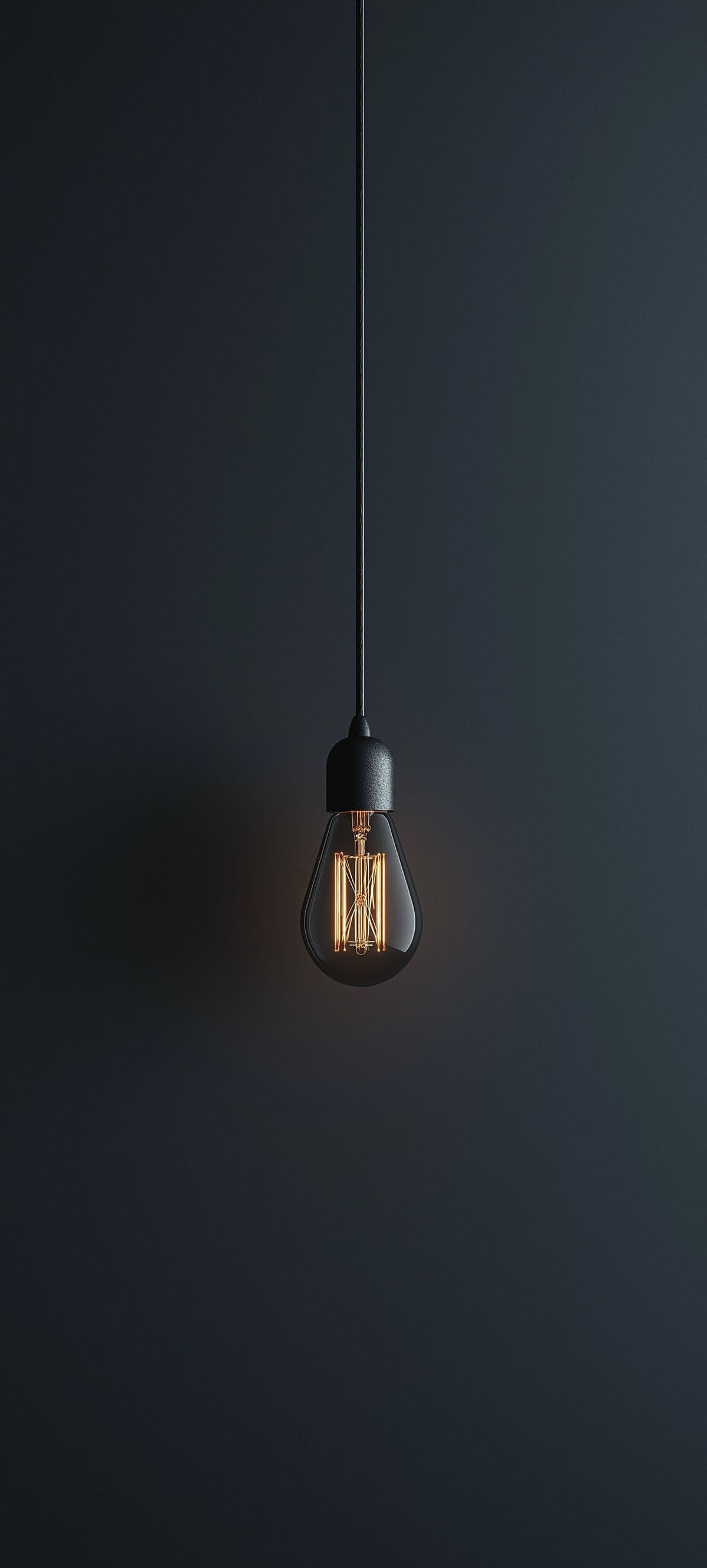 A lit lightbulb hanging on a long wire — the symbol of an idea